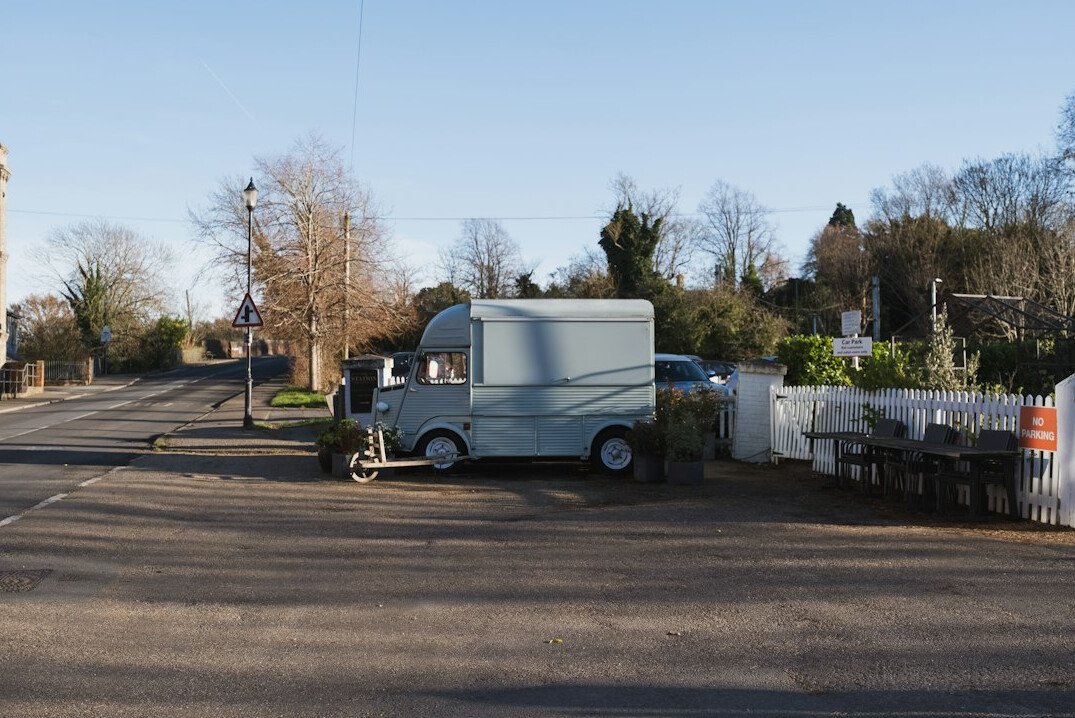 Outside broadcast van with satellite equipment parked near a venue