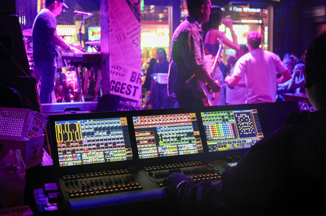 Broadcast control room with live video feeds on multiple screens